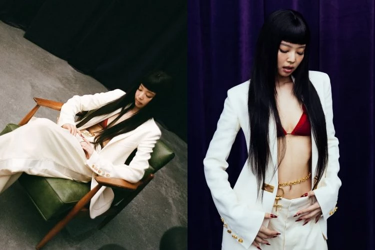 Jennie聯手Doechii的單曲〈ExtraL〉MV中，這套西裝外套穿搭關鍵在強烈對比。白色修身西裝本身理性克制，卻內搭紅色比基尼式上衣，視線瞬間被鎖定在胸口三角區塊。露膚面積其實不大，但因為外套肩線俐落、腰線微收，比例被框得很精準，腹部線條反而被拉長。