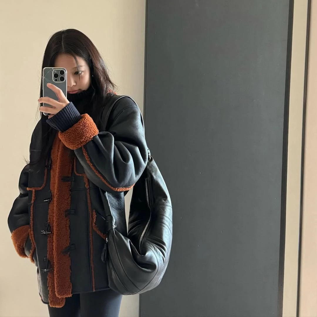 提到Lemaire,可頌包幾乎是許多時裝迷心中的第一個答案。包身以可頌麵包的弧形為靈感,透過拼接面板與打結細節勾勒出流暢曲線,整體輪廓柔和卻極具辨識度。Jennie私下穿也曾背上可頌包入鏡,低調卻相當搶眼。除了造型討喜,實用度也很到位,小款可放手機與錢包,中大型容量更充裕,雨傘也放得下,肩背、斜背或手提都可以,也難怪成為許多人入門Lemaire的第一款包。