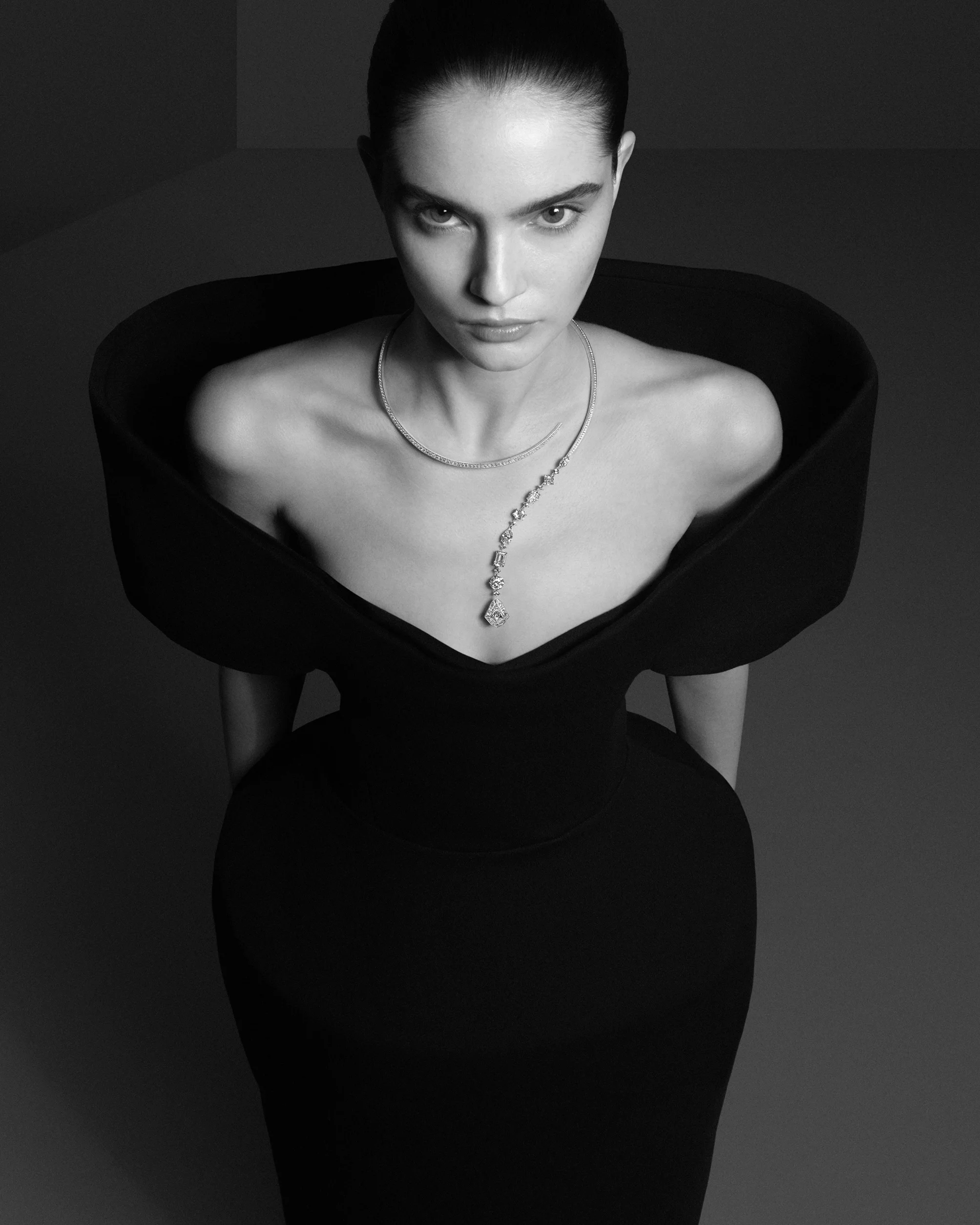 寶詩龍先生的「革命」,從來不是張揚的對抗,而是源於細膩而冷靜的觀察。他注意到當時女性被緊身衣、厚重服裝與僵硬珠寶層層束縛,於是提出一個簡單卻顛覆的詰問:為什麼珠寶不能順應身體而存在?1879年,他設計出史上第一條無扣環項鍊── Question Mark 問號項鍊。沒有鎖扣,也沒有固定起點,而是依靠隱藏式彈性結構自然環繞頸項,讓佩戴變成一個輕鬆而直覺的動作。這項設計在當時可謂離經叛道,卻為珠寶史開啟了全新的可能。今年的第二件作品〈The Spark〉,正是延續了這個經典問號所提出的問題。作品保留標誌性弧線,卻以多重幾何切割鑽石重新建構節奏,從橄欖形、阿斯切切割到祖母綠形,鑽石不再追求絕對對稱或整齊劃一,而是如音符般高低錯落,形成一種流動而有序的視覺律動。這不是什麼老調重彈,而是延續創辦人以質疑為起點的創作精神,從根本提問之中,孕育出始終與眾不同的美學答案。