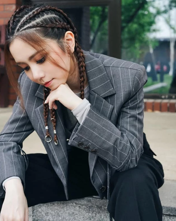 鄧紫棋在時髦與幹練之間游走的「都會雅痞風」。她捨棄了繁雜的色彩，轉而利用深灰色細條紋西裝外套，展現出一種冷靜的建築感美學，完美示範「如何將正式西裝穿出不羈的街頭靈魂」。